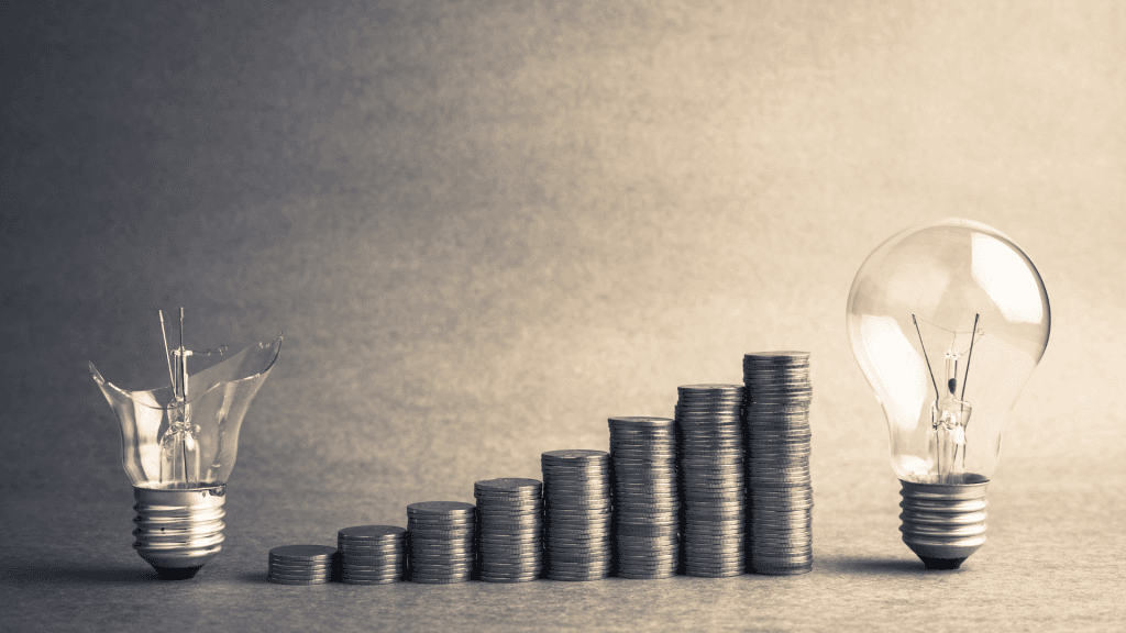 Picture of a broken light bulb on the left and a good light bulb on the right, with stacks of coins growing from left to right in between signifying the importance of using small bets and testing early and often in innovation.