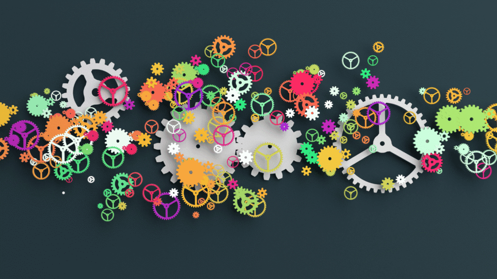 Image of colourful gears across a forest green background. The bright colours indicate opportunities for innovation throughout the complex processes of the SMB.