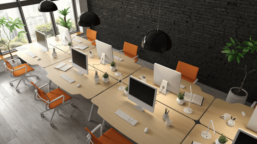 Picture of modern office space designed to encourage collaboration between team members with no cubicle walls or blocks between desks and with employees facing each other.