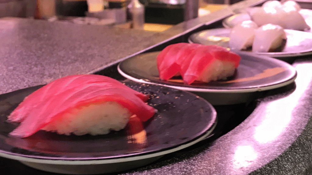 Example of a sushi conveyor belt used in a restaurant where customers can simply help themselves to sushi as it passes them at the table.